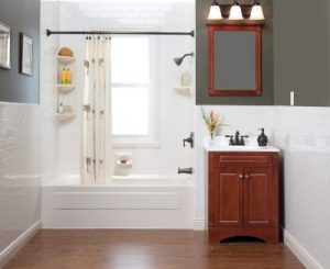 Showcase of new bathroom with a tub, shower, and wood vanity 