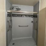 Silver frame shower in a cramped bathroom