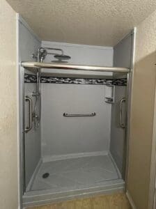 Silver frame shower in a cramped bathroom